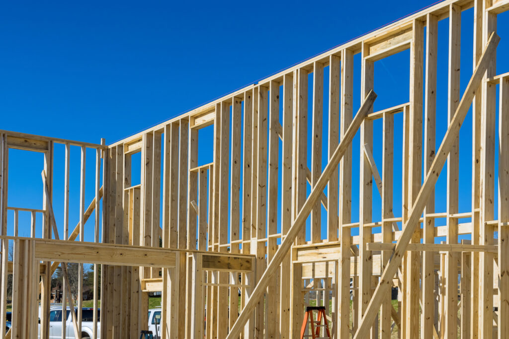 Commercial framing in progress with open spaces for windows and doors